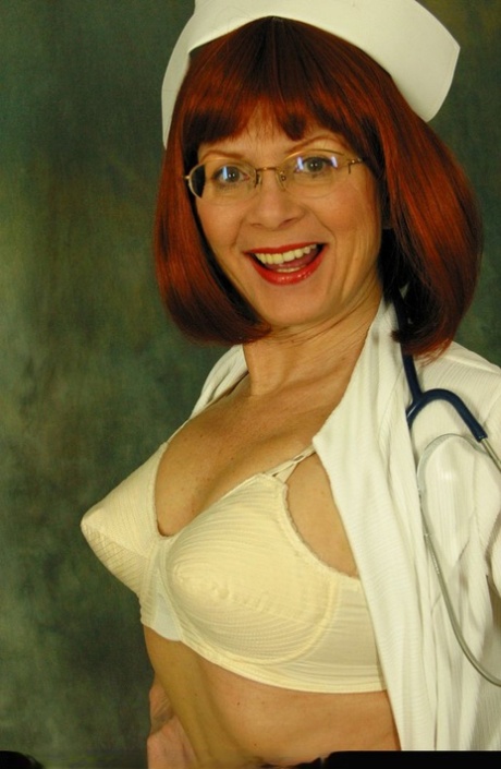 Older redheaded nurse Miss Abigail releases her natural tits from her uniform 24660593