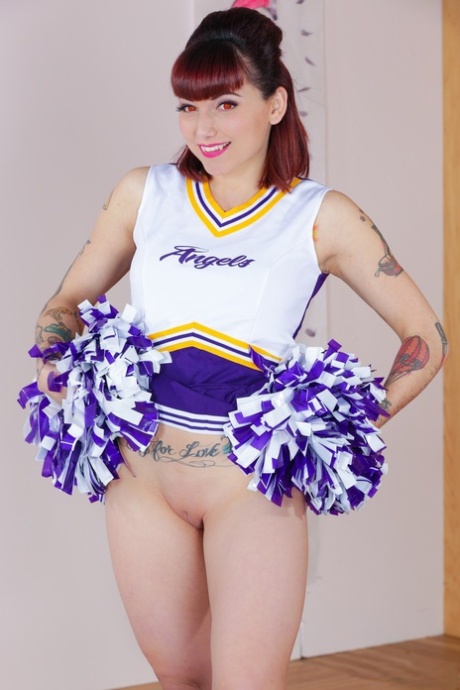 Tattooed cheerleader Veronica Layke offers up naked pussy on her knees 24437987