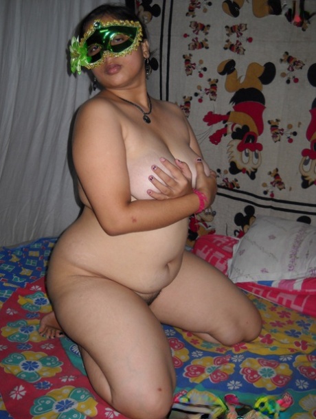 Fat Indian woman Juicy covers up her naked tits after getting naked in a mask 77113984