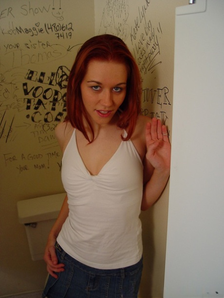 Young redheaded Smokey Flame gives oral sex while naked in a bathroom stall 76420862