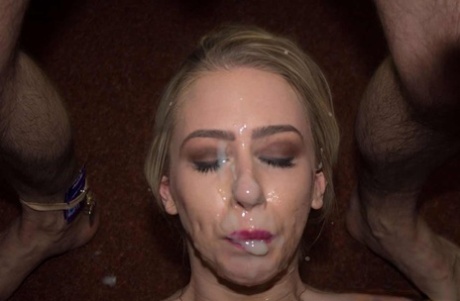Busty blonde receives open mouth cumshots during a bukkake party 35737940