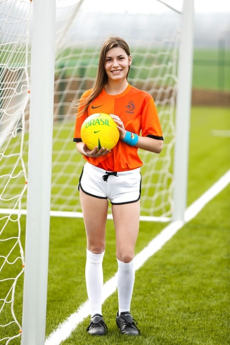 Lilly P is undressing her soccer uniform while on the field with a ball 48487729