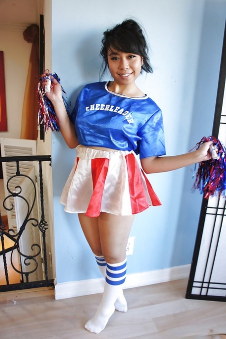 Petite Oriental cheerleader May Lee flashing black panties under skirt 59494601