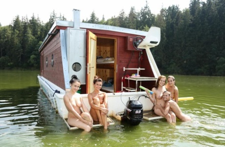 A group of teenage girls go rafting on a river in the nude