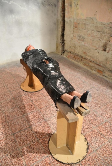 Naked female in high heeled shoes only is mummified in plastic and gagged 39820725