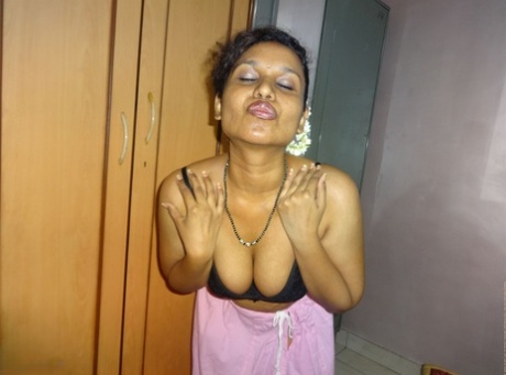 Clothed Indian woman strips to her black bra and underskirt 46627943