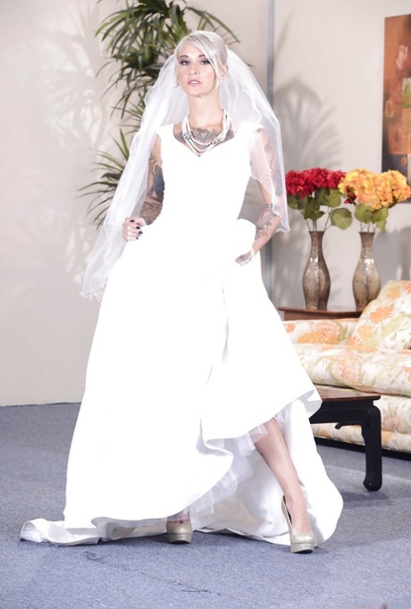 Stunning blonde bride in glamorous dress uncovering her tattooed curves 47181575