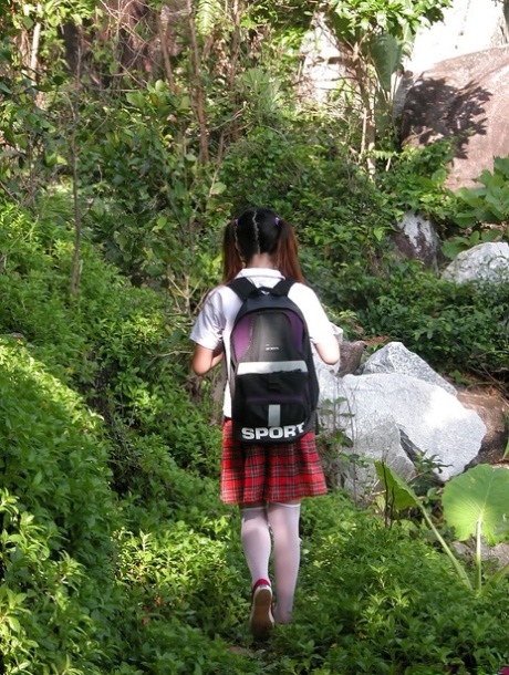 Adorable Asian shemale schoolgirl reading a book outdoors and spreading 54235282