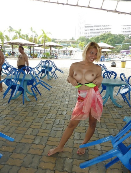 Busty Asian tranny flashing her big shemale breasts in public 56942606